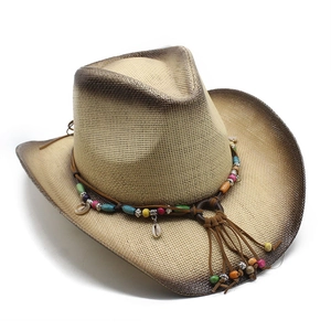 Detail of western straw hat featuring colorful wooden beads and leather fringe trim