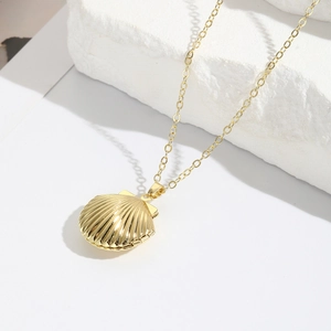 Elegant gold shell locket necklace for women featuring a detailed scallop pendant on O-chain