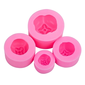 Set of four pink silicone persimmon molds for baking and candles in various sizes