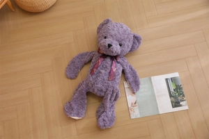 Detailed close-up of lilac teddy bear skin with unique rose texture faux fur and silk ribbon