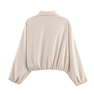 Back view of apricot baseball jacket featuring puff sleeves and elasticized hem detail