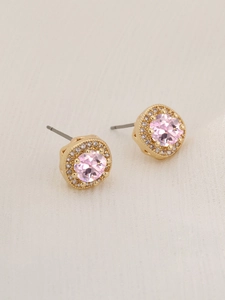 Detail of pink round zircon earrings with gold plating and white halo stones