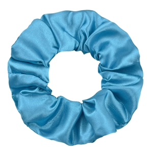 Detail of lake blue satin scrunchie showing smooth silk texture and pleated fabric