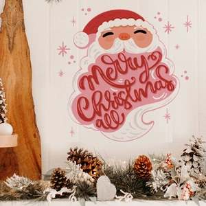 Detail of Santa Claus wall sticker with Merry Christmas greeting on a white wood wall