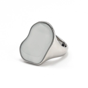Detailed close-up of irregular silver geometric ring with white inlay and mirror finish