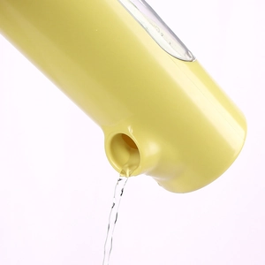 Close-up of the smooth water flow mechanism from a light yellow pet water fountain