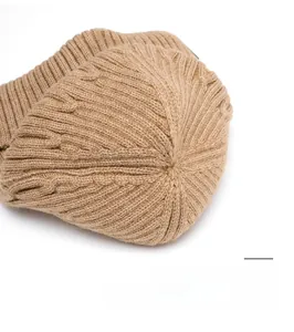 Detail view of khaki knit beanie top showing durable reinforced stitching and thick texture