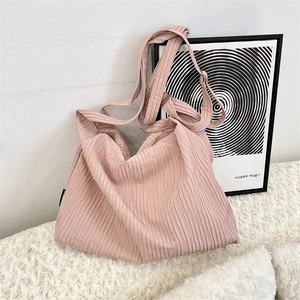 Detail of pink pleated canvas tote bag fabric and adjustable wide shoulder strap