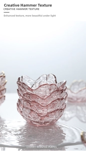 Detail view of stacked pink cherry blossom glass bowls with artistic hammer texture