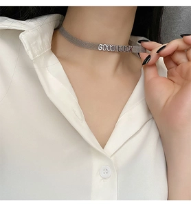Détail du collier choker tressé en acier inoxydable argenté avec pendentif Good Luck