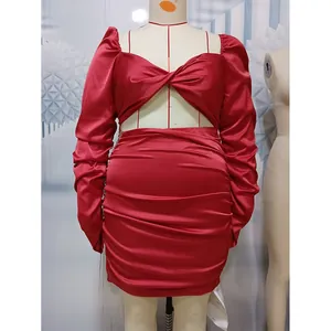 Detail of dark red satin dress with ruched texture, hollow front, and long puff sleeves