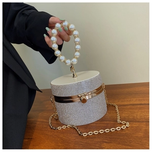 Silver rhinestone cylinder bag with large pearl handle and metal chain detail