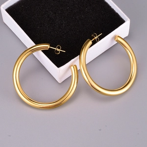 Close-up of thick gold-plated hoop earrings displayed with elegant jewelry box