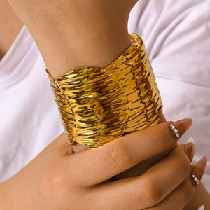 Adjustable 18k gold plated stainless steel cuff bracelet with textured wrinkled metal design