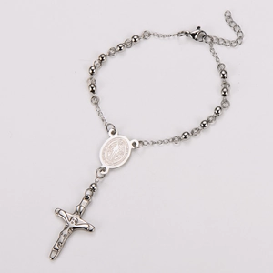 Detail of silver St. Benedict rosary bracelet with crucifix and religious medals