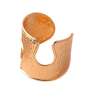 Wide gold metal open cuff bracelet featuring artisanal hammered texture and crumpled finish