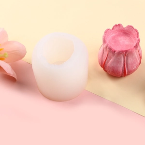 Detail view of pink peony candle next to its semi-sphere silicone mold for DIY crafts