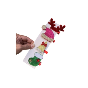Détail du lot de 4 barrettes de Noël avec paillettes en forme de renne et bonnet de Noël