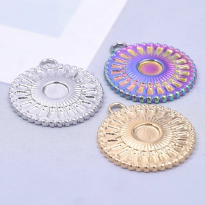 Three round stainless steel DIY pendants in gold, silver, and rainbow colors