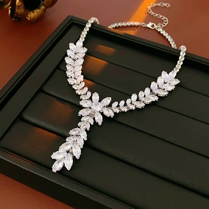 Macro shot of silver wheat tassel necklace with sparkling zircon leaf-shaped gemstones