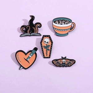 Gothic enamel pin set with skull moth and heart dagger on light purple background