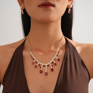 Elegant gold-plated jewelry set with red square gemstones and sparkling crystal fringe
