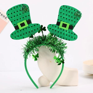 Detail of St. Patrick's Day headband featuring green mini hats and shamrock sequins