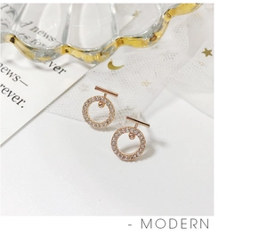 Detailed shot of rose gold geometric hoop earrings with sparkling pave zircon stones
