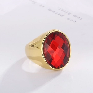Close-up of gold-plated stainless steel ring with a large oval red faceted glass stone