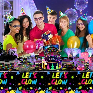 Close-up of neon glow party supplies set with plates and cups for birthday events