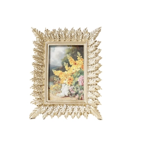 Golden leaf resin photo frame with vintage carving and flower oil painting on white background