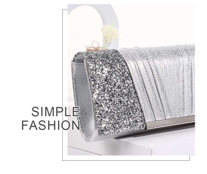 Detail of silver evening clutch featuring sparkling sequins and metallic pleated textures