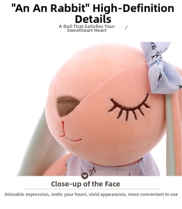Close-up of pink plush bunny face showing detailed embroidery and floral bow decoration
