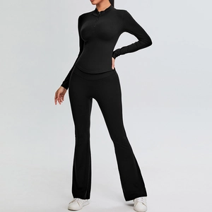 Slim fit black yoga set with half-zip long sleeve top and high waisted flare leggings