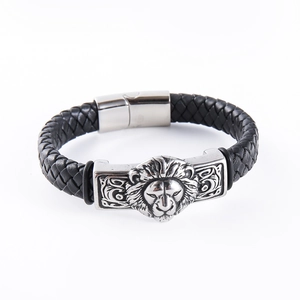 Detail of a men's punk lion head bracelet with black braided leather and magnetic clasp