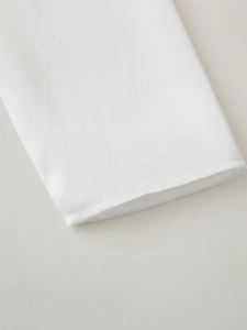 Close-up detail of the white cotton sleeve cuff with high-quality stitching on a shirt