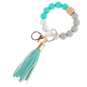 Close-up of MAMA silicone bead keychain with teal faux leather tassel and gold ring