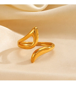 Detailed close-up of a minimalist gold geometric open ring on elegant satin fabric