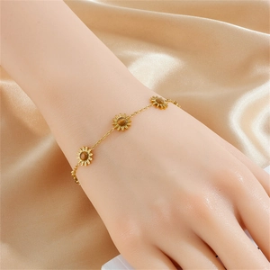 Gold-plated stainless steel bracelet with daisy pendants and brown cat-eye stones