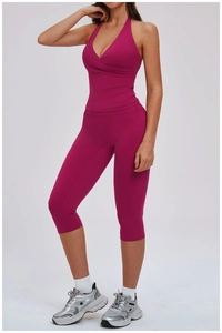 Detail of plum red yoga set showing halter cross sports bra and high-waist cropped leggings