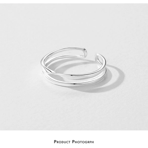 Macro shot of silver double-layered twisted crossover open adjustable ring band
