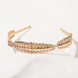 Close-up of golden metal leaf headband with detailed laurel wreath texture and 2cm width