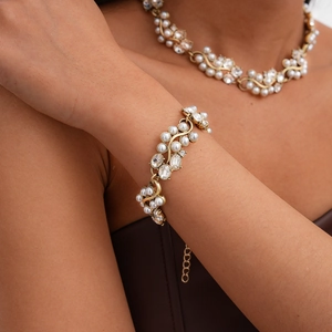 Close-up of vintage baroque necklace and bracelet with pearls and crystals on a model