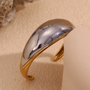 Detail of two-tone stainless steel cuff bracelet with silver polish and gold matte finish