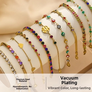 Detail of gold titanium steel bracelets with colorful zircon and evil eye motifs