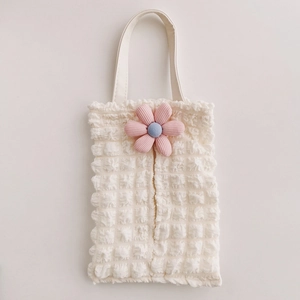 Macro shot of bubble textured fabric tissue holder with a pink 3D flower detail