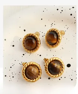 Detailed view of vintage gold tiger eye earrings with silicone and metal butterfly backings