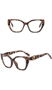 Macro detail of retro oversized cat-eye frames in amber tortoiseshell with clear lenses