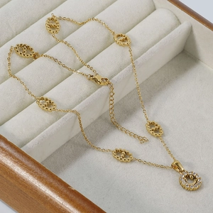 Gold hollow double-ring necklace with sparkling round diamond pendant on velvet display