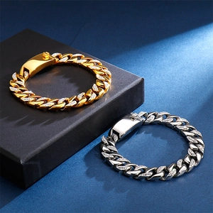 Close-up of gold and silver iced-out Cuban link bracelets with sparkling zircon stones